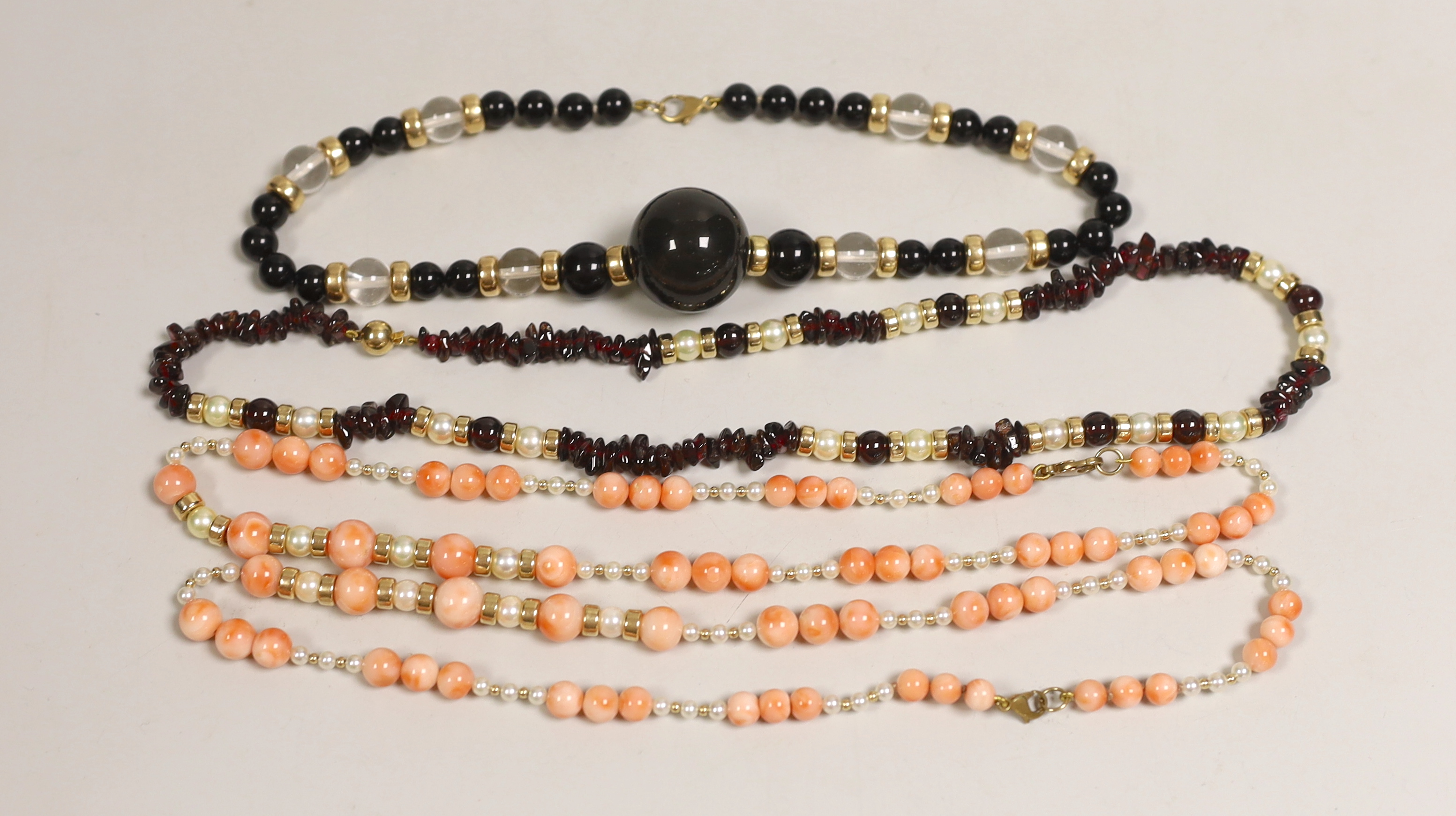 A modern garnet and cultured pearl necklace with yellow metal spacers and clasp, 48cm and three other necklaces.